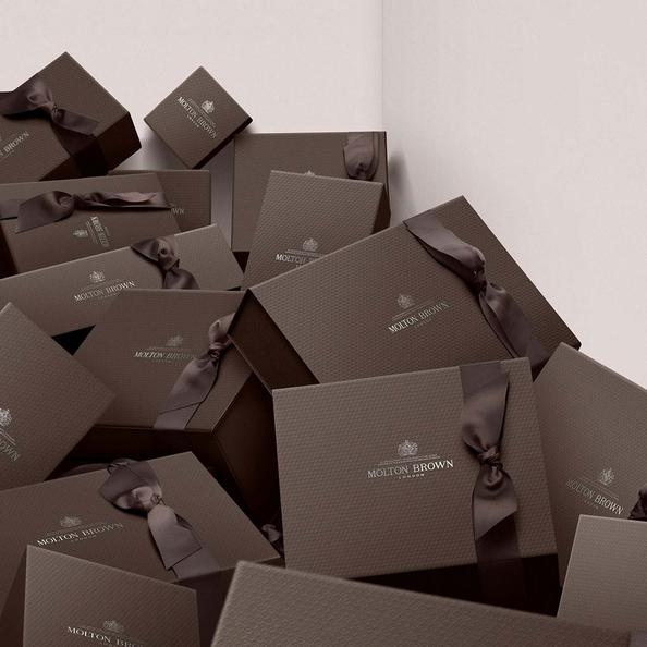 An image of Molton Brown Signature Packaging boxes in a corner of a room