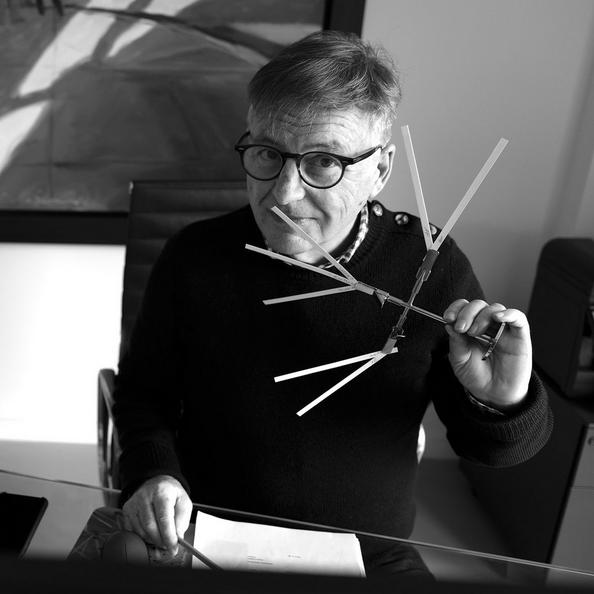 An Image of Jacques Chabert Holding Fragrance Sticks To His Nose