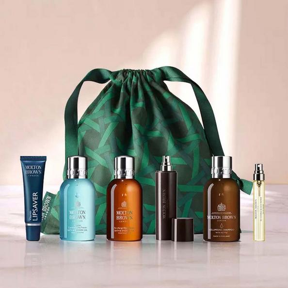 An Image of A Molton Brown Travel Drawstring Pouch with a Collection of Molton Brown Travel Products